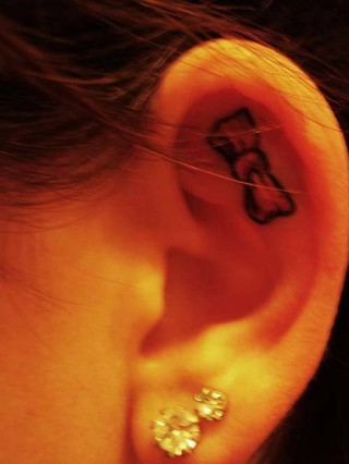 bow tattoo in ear 