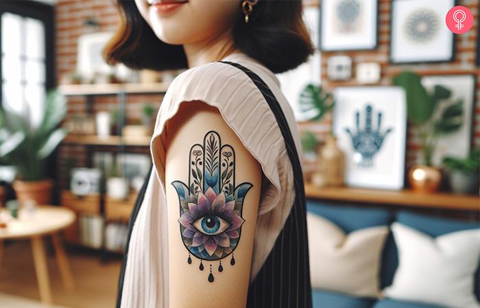 Colorful hamsa tattoo on the upper arm