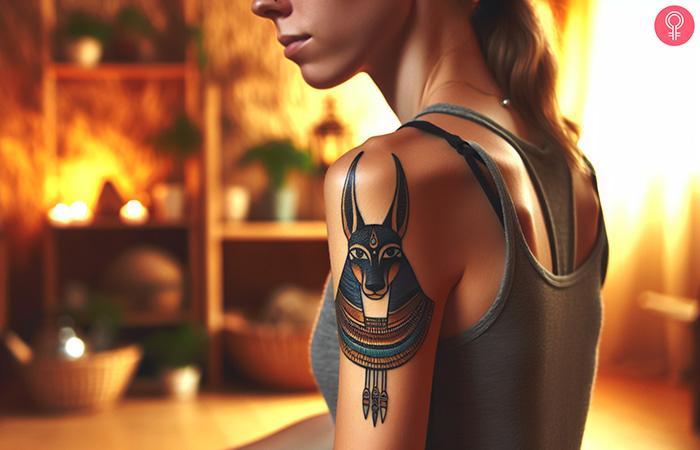 Egyptian gods tattoo on the upper arm