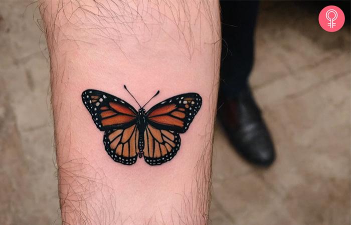A monarch butterfly tattoo for men on the forearm