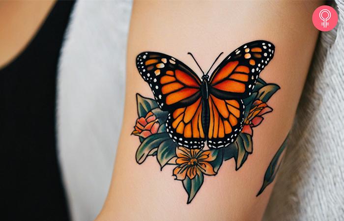 A traditional monarch butterfly tattoo on the upper arm