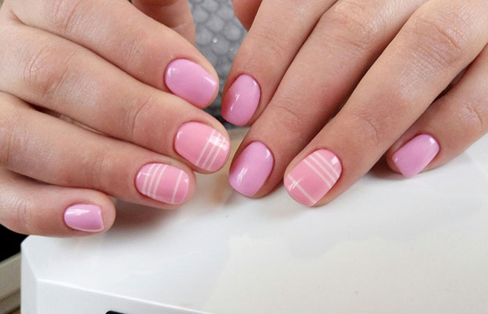Pink manicure with white stripes