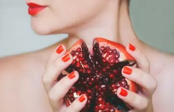 Woman holding pomegranate 