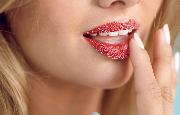 Woman exfoliating her lips