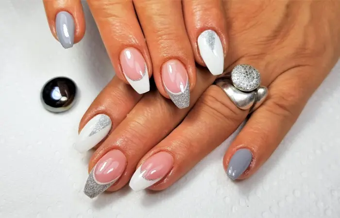 Close up of a woman’s fingers with beautiful ballerina shaped nails 