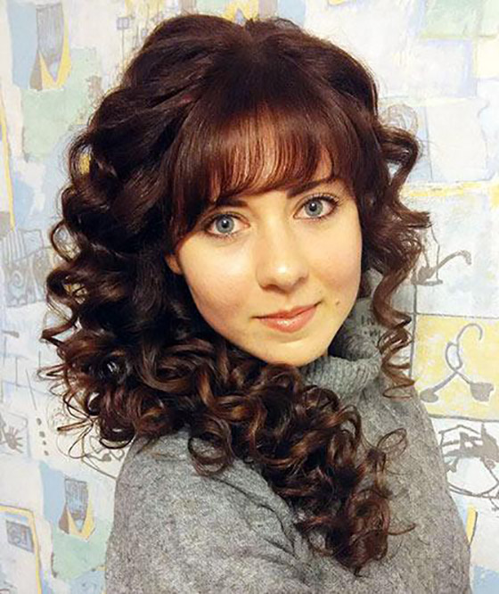Tight curls with fringes hairstyle to slim down round faces