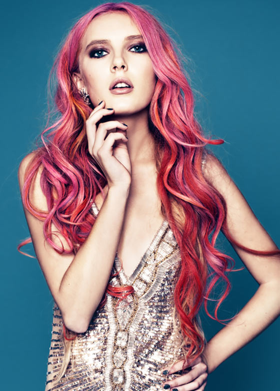 Coral pink wavy layered hairstyle for a square face