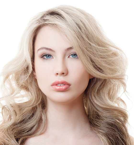 Long blonde waves with side-swept bangs hairstyle for a square face