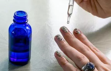 Person applying olive oil on nails