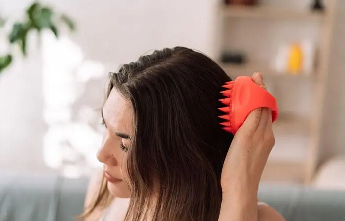 Woman giving herself a scalp massage