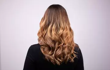 Woman with highlighted coffee layered hairstyle