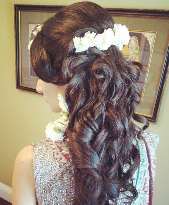 Curls with a floral centerpiece for an Indian hairstyle