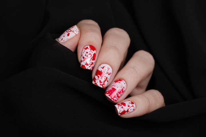 Alt text: white and red splatter nail art