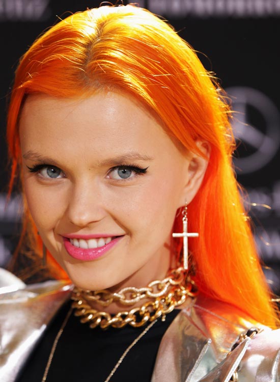 Center parted bright orange hair with side fringes