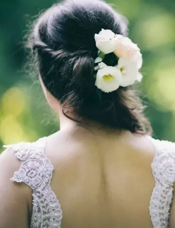 Curls with a floral centerpiece for an Indian hairstyle