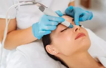 Dermalogist treating woman's dark spots