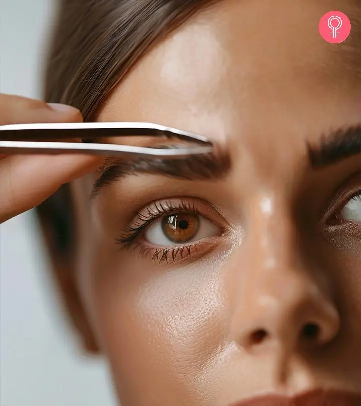 A girl tweezing her eyebrows