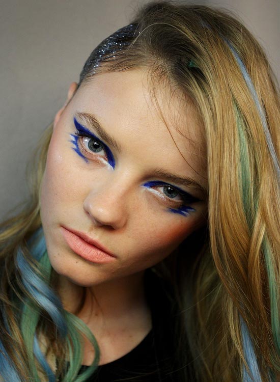 Light golden brown hair with pastel blue and green streaks
