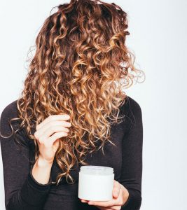Woman applying a homemade conditioner for curly hair
