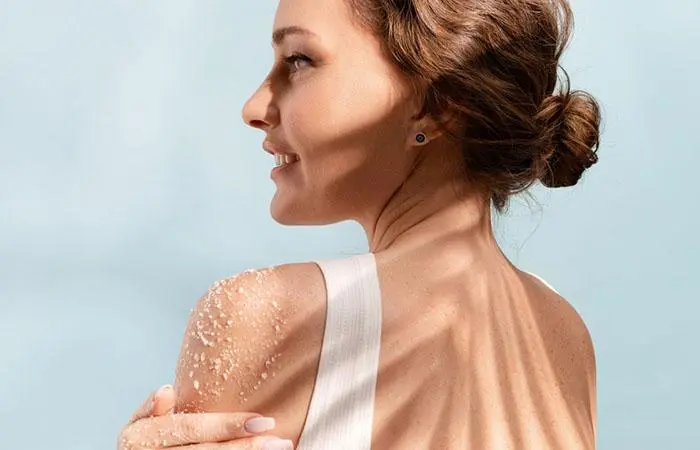 Woman applying sea salt scrub