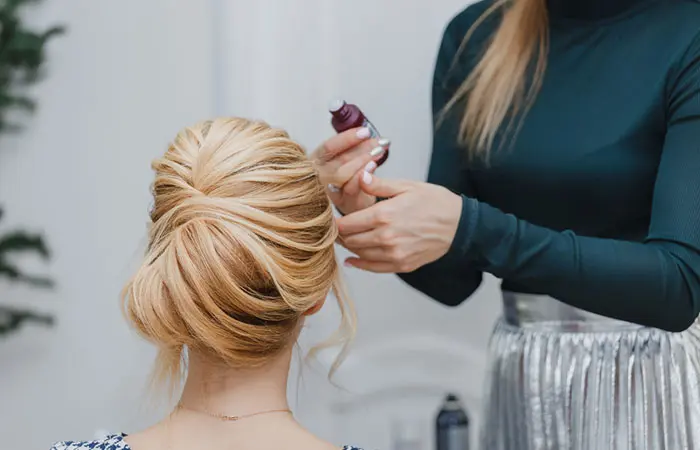 A girl getting her hair done for prom