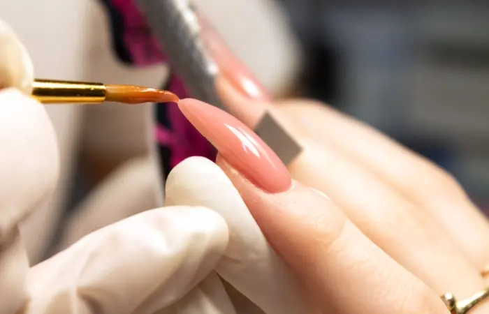 A woman with peach gel nail polish