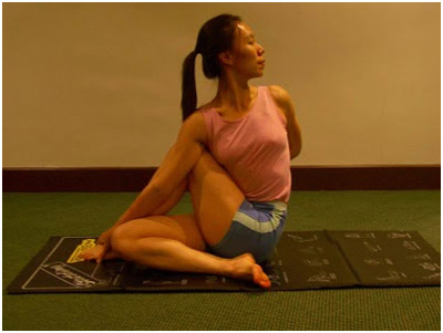 Seated spinal twist in yoga for weight loss