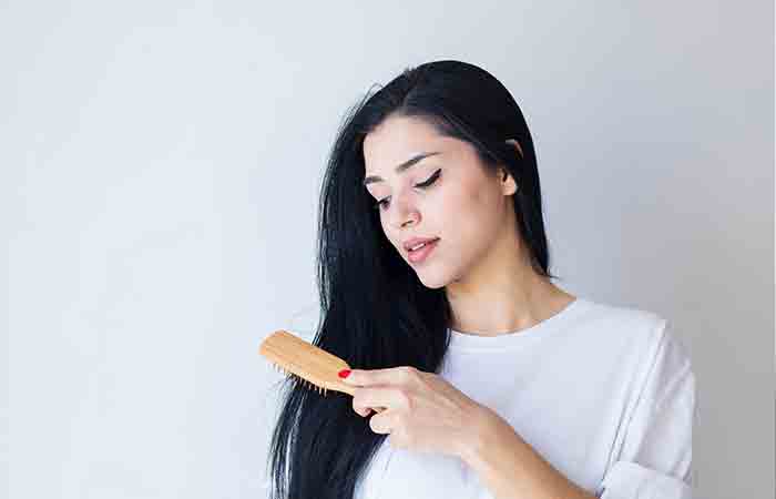 Woman brushing her black hair