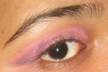 Apply purple eyeshadow on outer edge of eyelid as step 4 of Arabic eye makeup