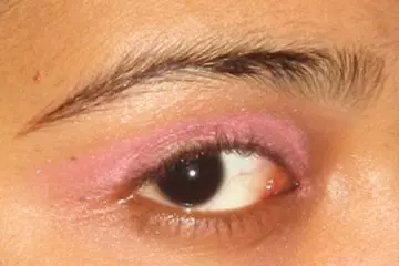 Apply pink eyeshadow on lids as step 3 of Arabic eye makeup
