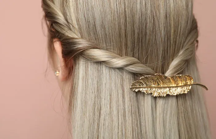 A woman with long hair accessorized with an antique clip