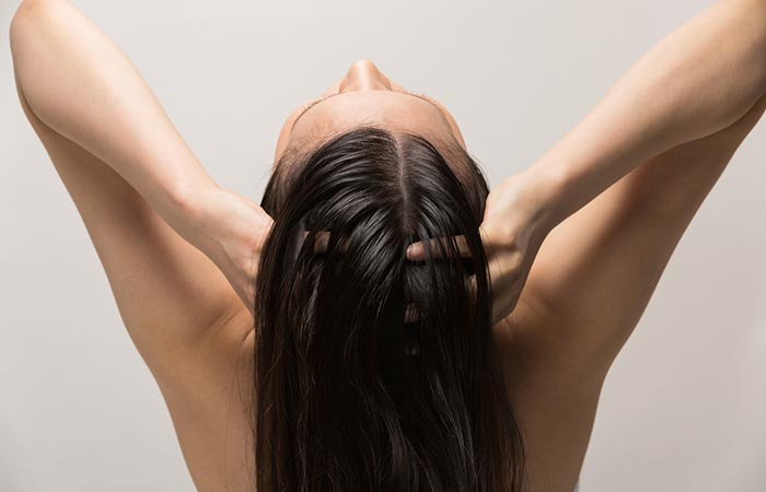 Massage the acupoint at the top of your head to reduce hair fall