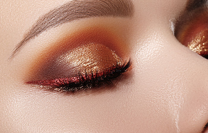 Close up of metallic red glitter eye makeup