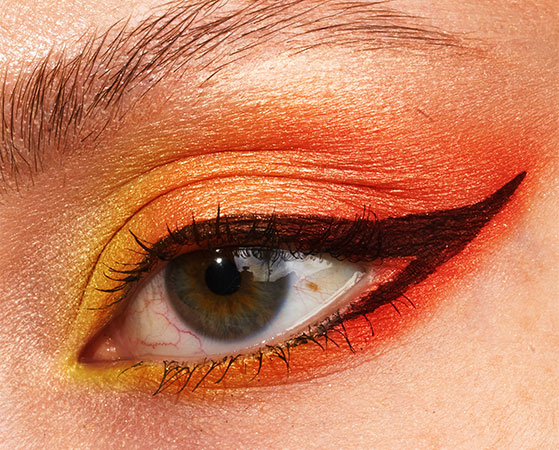 Close up of yellow and orange sunset eye makeup