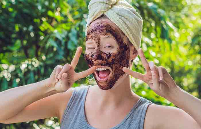 Woman with coffee scrub on her face to exfoliate blackheads