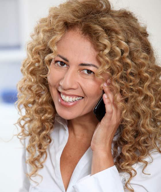 Beautiful happy plus size sexy woman with curly hair in light blue