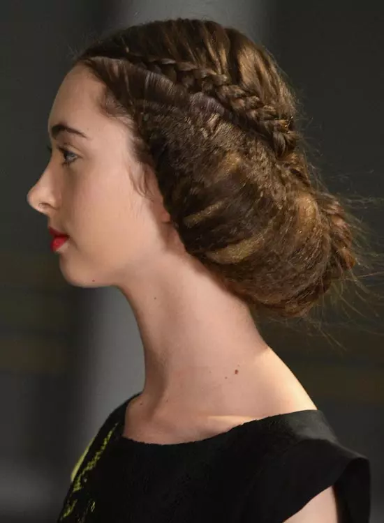 Messy braided bun hairstyle for frizzy wavy hair