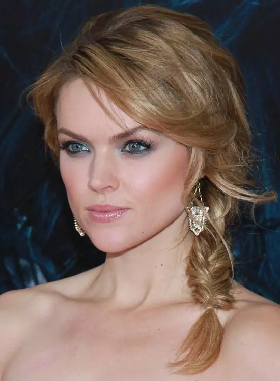 Messy side braid hairstyle for frizzy wavy hair