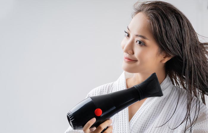 To blow dry different types of hair, begin the drying process starting with the lower sections