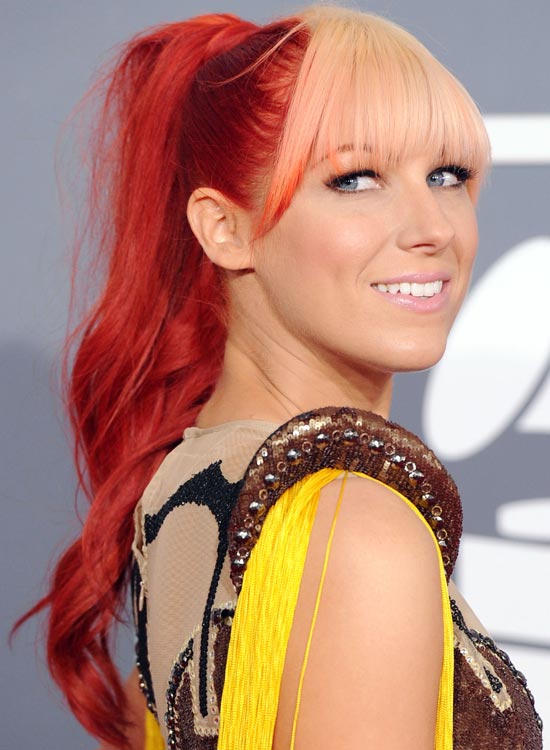 High wavy copper-red ponytail with peach fringes punk wavy hairstyle