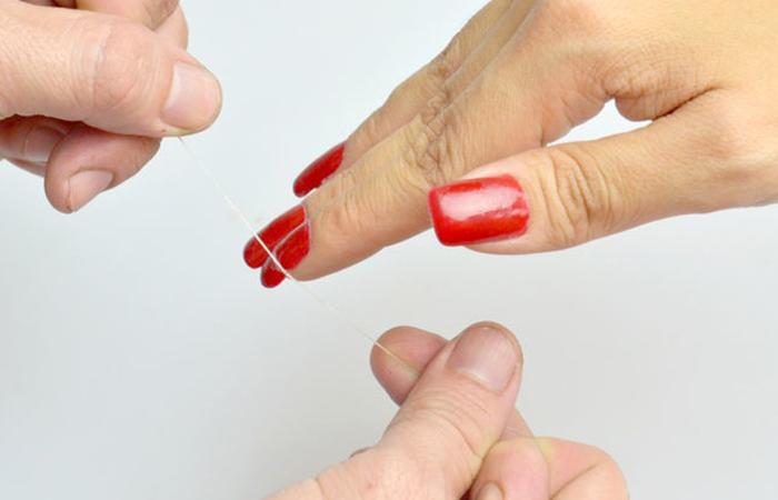 Remove acrylic nails using dental floss