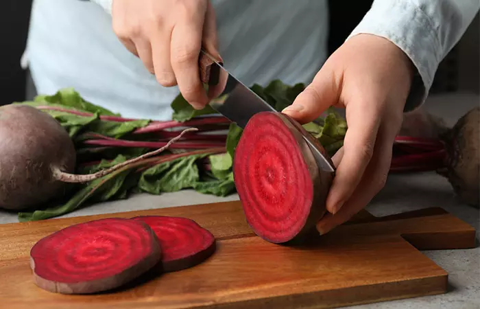 Woman cutting beetroot
