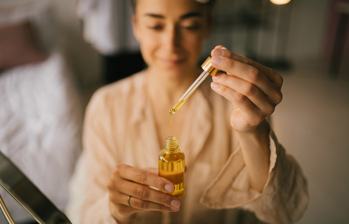 Woman using jojoba oil for hair