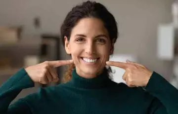 Woman showing her healthy teeth after using cinnamon