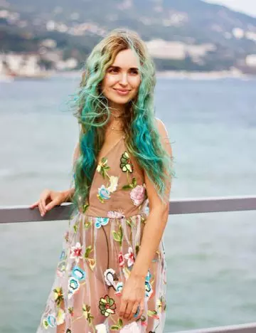 A woman with mermaid hair posing by the sea