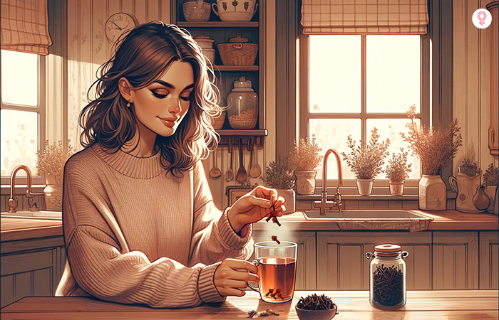 A woman adding cloves to her tea
