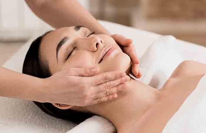 Woman getting a facial massage at a spa