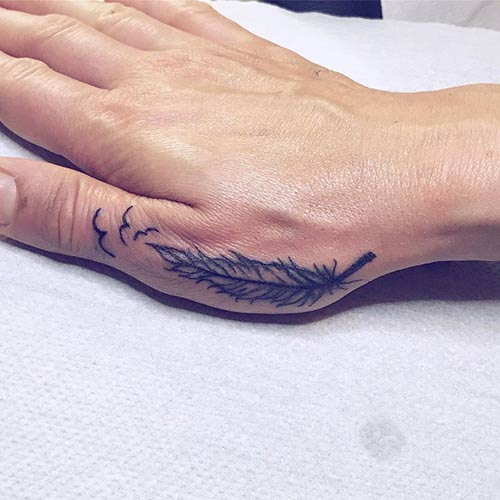 Single feather hand tattoo design