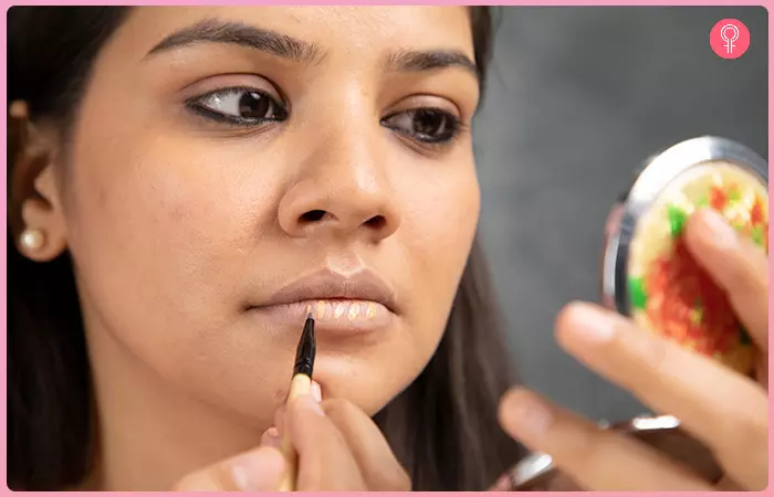 Applying foundation on the lower lips