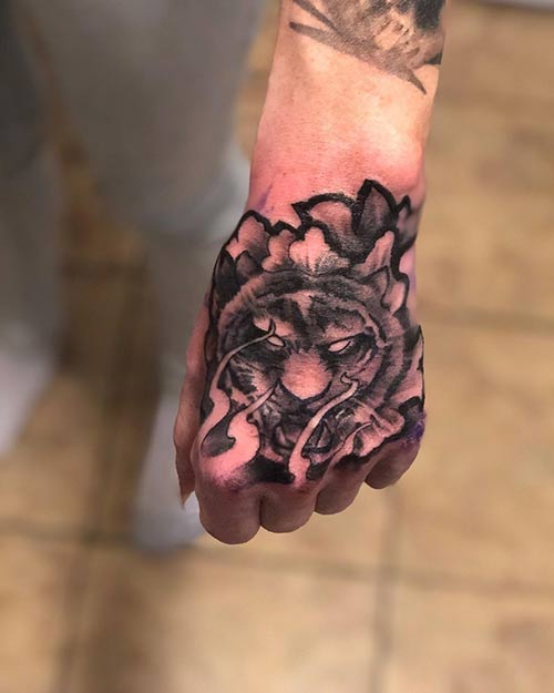 Fierce tiger face hand tattoo design